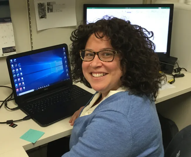 Beth Otero working at her desk.